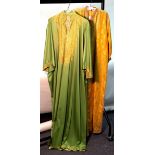 A yellow embroidered kaftan and another in green