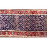 A late 19th Century North West Persian Kurdish runner with shrub design,