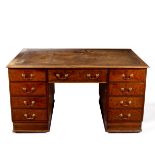 A partners' burr walnut desk, fitted drawers to one side and cupboard and drawer to the other,