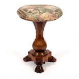 A Victorian rosewood piano stool with circular top, vase-shaped column on claw feet,