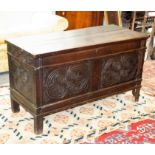 17th Century oak coffer with decorative carved panels to the front and sides,