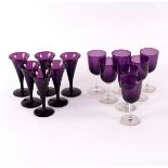 Six amethyst glass wine glasses with tapered bowls and circular bases,