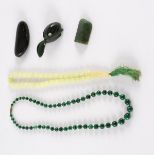 A collection of Maori moss agate figures, a beaver, a turtle, a malachite bead necklace,