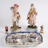 A pair of early 20th Century Continental figures, stock man with companion, 20.