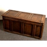 A 17th Century oak coffer with triple-panel cover and front,