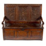 An early 18th Century carved oak settle,
