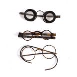 A pair of steel framed spectacles in a case with hinged cover,