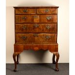 An early 18th century figured walnut and herringbone banded chest on stand,