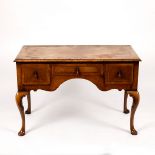 A walnut kneehole dressing table, fitted three drawers on cabriole legs,