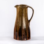 Jim Malone (British, born 1946), a cut sided jug with tenmoku glaze,