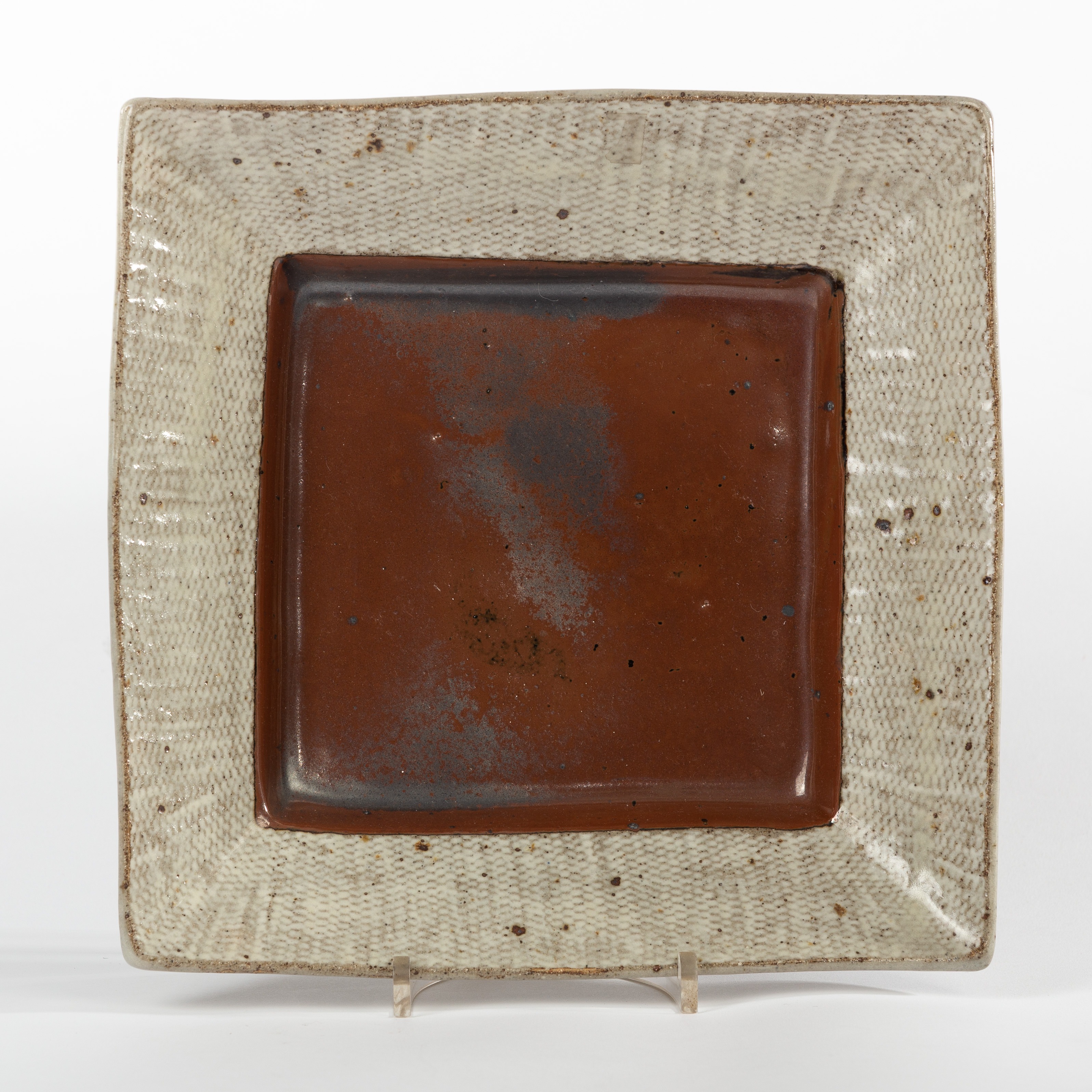 Shimaoka Tatsuzo (Japanese 1917-2007), a square stoneware dish, the centre with mottled brown glaze,