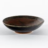 Henry Hammond (British 1914-1986), a shallow stoneware bowl, the interior glazed in mottled red,