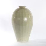 William 'Bill' Marshall (British 1923-2007), a facetted ovoid stoneware vase, in pale celadon glaze,