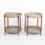 A pair of modern circular two-tier tables, with dished surrounds,