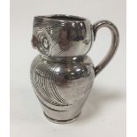 Style of Archibald Knox, a silvered ceramic jug in the form of an owl,