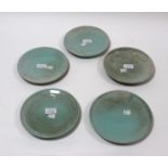 Sibley Pottery, five plates with celadon glaze incised stylised waves,