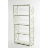 A modern bookcase or display unit, painted green frame with trellis type open sides,