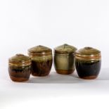 Richard Batterham (British, born 1936), four stoneware lidded caddies, ash and tenmoku glazes,