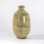 Paul Barron (British 1917-1983), a celadon glaze bottle vase of ribbed design with dripped glaze,