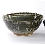 Studio Pottery, a stoneware bowl, wax resist design of grass on a khaki ground,