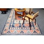 An Eastern rug of geometric design, the indigo blue field within a multiple border,