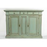 A green painted cupboard with drawers over, each cupboard enclosed by a panel door,