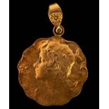 An Art Nouveau 15ct gold pendant locket depicting a lady in profile and with wavy border,
