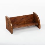 An Arts & Crafts oak book trough, with carved acorn to each end,