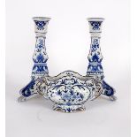 A pair of Rouen faience candlesticks and a blue and white bowl (damaged) (3)