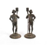 A pair of spelter figural candlesticks modelled as pages,