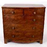 An early 19th Century mahogany bowfront chest of three long and two short drawers on bracket feet,