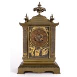 A gilt brass and metal mantel clock with chinoiserie decorated panels,