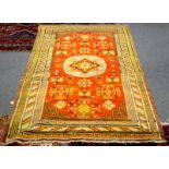 An Eastern rug with a central medallion on an orange ground,