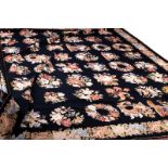 A needlework carpet decorated floral sprays to a black ground,