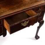 A George II walnut lowboy fitted five drawers, on carved cabriole legs with ball and claw feet,