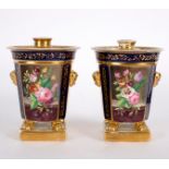 A pair of French porcelain bough pots, painted panels of flowers on a dark blue ground, circa 1810,