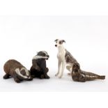 Four pottery models of animals, comprising two pottery badgers, modelled by Gil Tregunner,