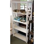 A set of open shelves with X-shaped supports to the sides,