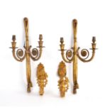 A pair of gilt metal curtain tie backs,