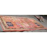A Khotan rug decorated vases of flowers 244cm x 125cm and another similar,
