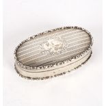 An oval silver box, Chester 1906, the engine-turned lid with central cartouche, 12cm wide,