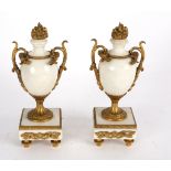 A pair of white marble garniture urns with gilt metal mounts,