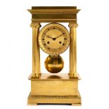 An Empire ormolu portico clock with four Ionic column supports,