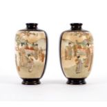 A pair of Satsuma vases painted reserves of figures in a garden landscape,