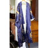 A Japanese blue silk kimono embroidered in gold thread with entwined dragons,