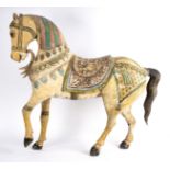 An Indian carved, painted and decorated wooden horse,