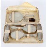A silver backed travel dressing set, TP, London 1953, comprising hairbrushes,