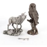 A filled silver model of an owl on a stump, 22.