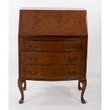 A Queen Anne style walnut bureau on cabriole legs with shell carved knees,