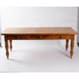 A pine farmhouse table, fitted three drawers to one side on turned legs, the top 202cm x 84.
